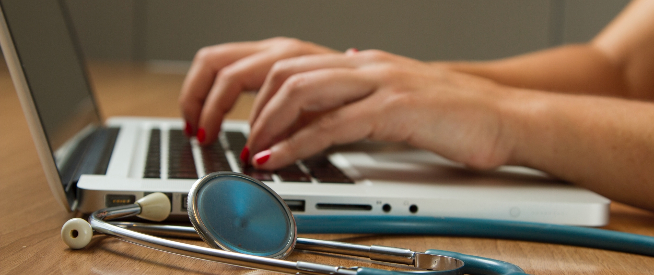 Healthcare professional typing on keyboard